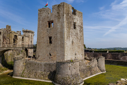 Stone keep and moat of the historic 15th-century Raglan Castle ruins in South Wales