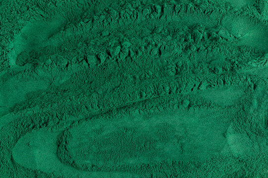 Spirulina powder with rich green texture background