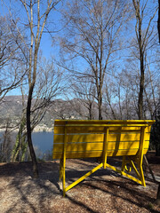 Giant yellow bench on a hill over Lake Garda, Italy
