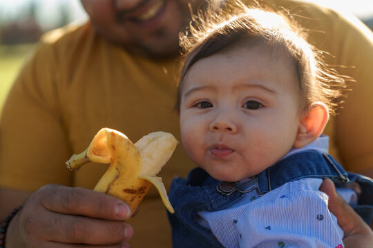 Father and child enjoying outdoor snack time together