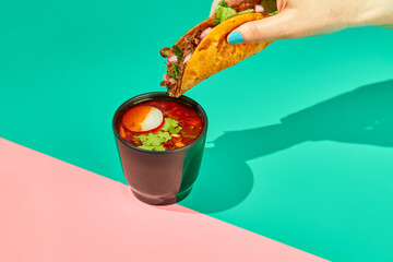 Traditional mexican birria ramen consomme soup and tacos with braised beef. Dip tacos in broth.