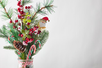 Christmas arrangement in a vase, a bouquet of fir branches and decorative Christmas ornaments