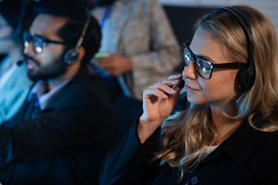 customer service agent, wearing a headset talking with client. Technical support, call center, telemarketing, online communication, IT support late at night shift - Powered by Adobe