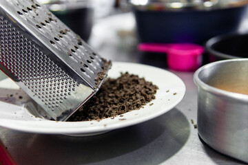 Grating chocolate for sweet dessert preparations