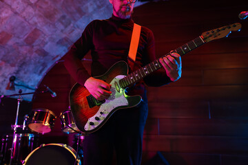 Man playing electric guitar on stage, closeup