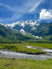 mountain landscape with stream on a July Day in the French Alps 