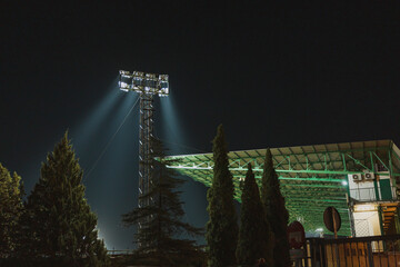 Nighttime illumination of a sports stadium with bright lights