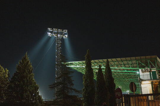 Nighttime illumination of a sports stadium with bright lights