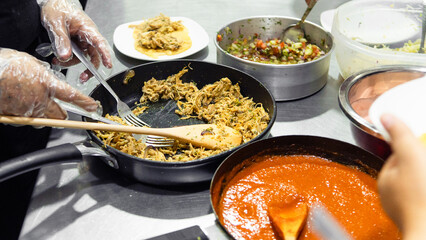 Hands preparing traditional honduran food in cooking class