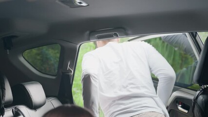 Inside view of vehicle showing cheerful kids stepping out with excitement surrounded by green autumn forest, sunlight reflecting through windows, capturing warm travel atmosphere
