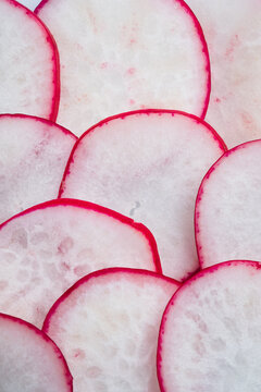 Macro view of fresh radish slices with red edges