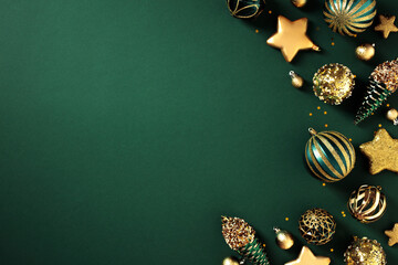 Luxury Christmas greeting card template. Top view green and gold Christmas decorations on dark...