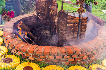 Traditional gaucho barbecue in Brazil: beef ribs slow-roasting vertically on iron frames over a wood-fueled open fire, yielding smoky, tender meat and showcasing rural culinary heritage.