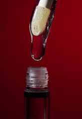 Lip oil applicator with clear glossy formula and bubbles on red background, collection of macro shots for cosmetic branding, skincare hydration and beauty product advertising banners
