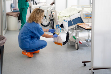 Nurse performing critical care in intensive care unit