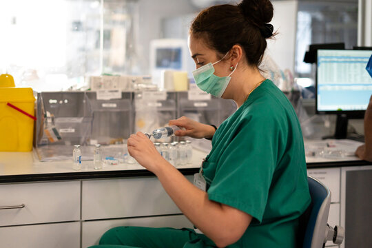 Nurse performing critical care duties in ICU