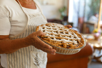 Woman holding homemade dessert apple pie 