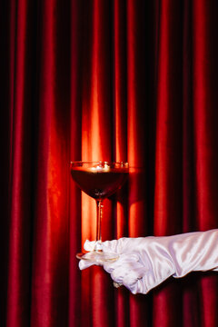 Elegant cocktail served on a luxurious red backdrop