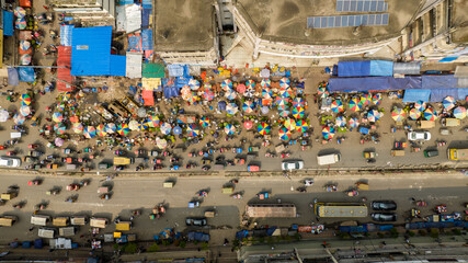 Aerial view of vibrant chaos unfolds in Mirpur 1, with a sea of colorful umbrellas and bustling traffic, Dhaka, Dhaka, Bangladesh.