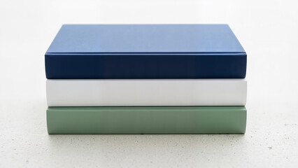 Stack of colorful hardcover books on a minimalist background