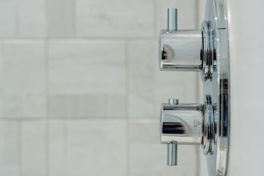 Modern bathroom detail with chrome shower controls