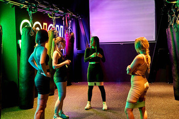 Women engaging in a workout session in a vibrant fitness studio