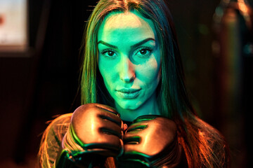 Female boxer prepares for training with determination
