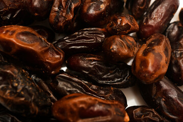 Juicy dates on a plate. Dried fruits. Sweet dried fruits.