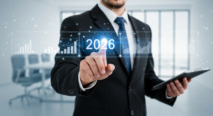 Confident executive forecasts future growth by touching digital 2026 analytics display in modern office