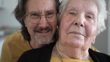 Elderly woman receives loving attention and support in a home healthcare facility setting with family presence.