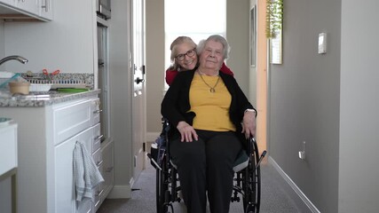 Elderly woman in wheelchair receives assistance from caregiver while moving through a home healthcare facility.