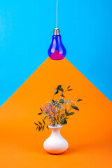 Geometric Still Life with Purple Light Bulb On Wire and Vase with Flowers