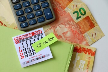 Brazilian 13th salary concept with "13º Salário" text, BRL Real banknotes, calendar and calculator. 13º salário Brasileiro. 