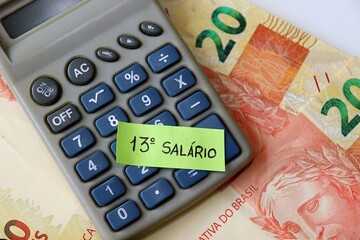 Brazilian 13th salary concept with "13º Salário" text, BRL Real banknotes, and calculator. 13º salário Brasileiro. 