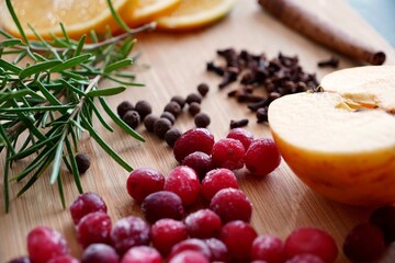 Top View of Oranges, Apples, Cranberries, Rosemary, and Spices on Cutting Board — Natural Potpourri Ingredients