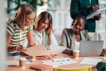 Diverse business team collaborating on data analysis in office