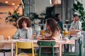 Diverse group collaborating on project in modern office