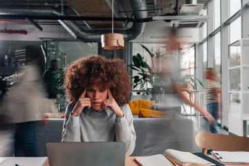 Overwhelmed woman suffering headache in busy office