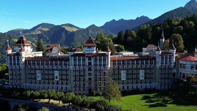 Aerial drone footage of SHMS Swiss Hotel Management School campus in Montreux, Switzerland, showcasing modern architecture, scenic Lake Geneva, and surrounding mountains