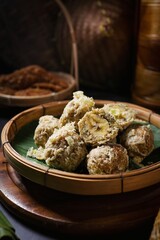 Thai Deep fried Banana with Pounded Unripe Rice (Khao Mao Tod) on bamboo basket,Crispy Fried Banana balls