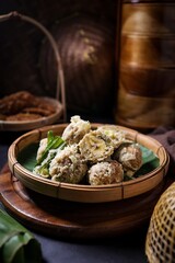 Thai Deep fried Banana with Pounded Unripe Rice (Khao Mao Tod) on bamboo basket,Crispy Fried Banana balls