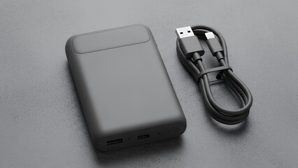 A gray power bank and cable on a gray background