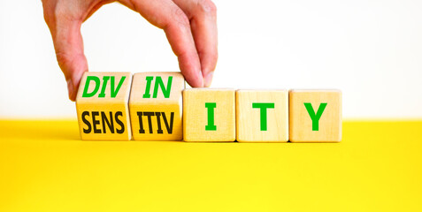 Sensitivity or divinity symbol. Concept words Sensitivity or Divinity on wooden cubes. Beautiful...