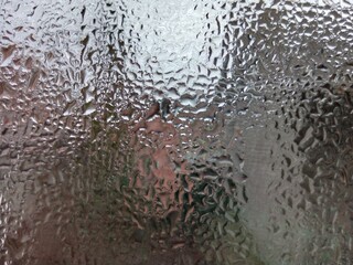 Condensation on Glass Surface with Abstract Reflections
