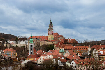 Obraz premium the view of the colorful roofs of Cesky Krumlov and a medieval castle towering over the town. Czech Republic