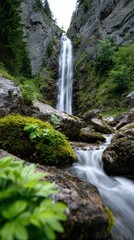Fototapeta premium vertical waterfall shot, a tranquil, cinematic vertical shot captures a majestic waterfall cascading down a sheer rock face in a lush alpine setting