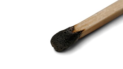 Closeup view of a wooden matchstick with a charred tip, isolated on white background.