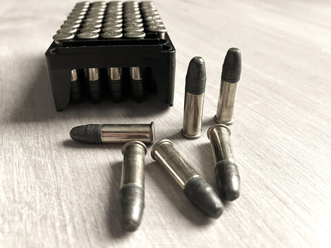 Pack of .22LR caliber bullets on wooden floor