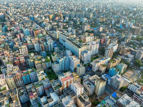 Aerial view of buildings casting shadows in dense urban sprawl, the sky hazing over the city, Dhaka, Dhaka Division, Bangladesh.