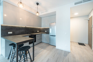 Modern Minimalist Home Kitchen Interior with Stylish Furniture and Lighting Pieces